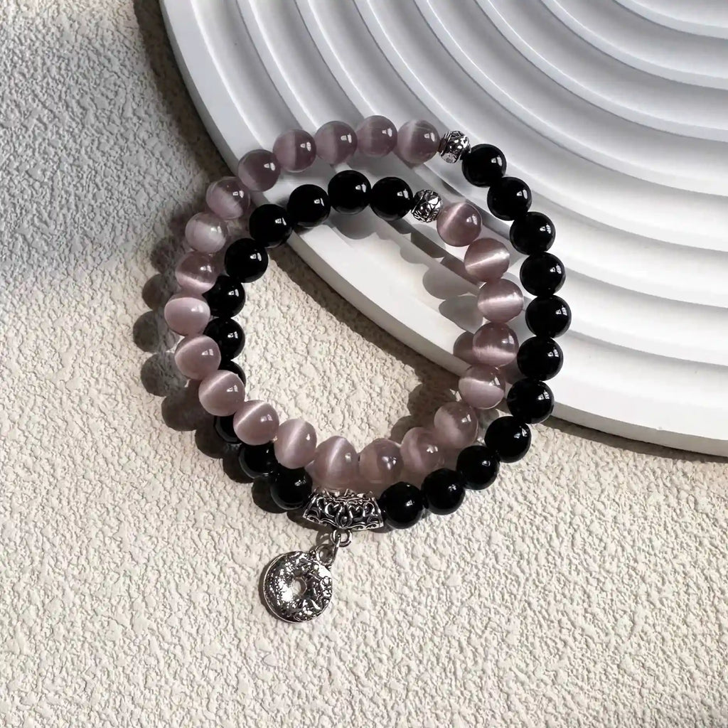 Black obsidian and pink cat eye double wrap bracelet displayed to symbolize protection, love