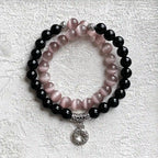 Bracelet featuring black obsidian stones and pink cats eye crystal for protection