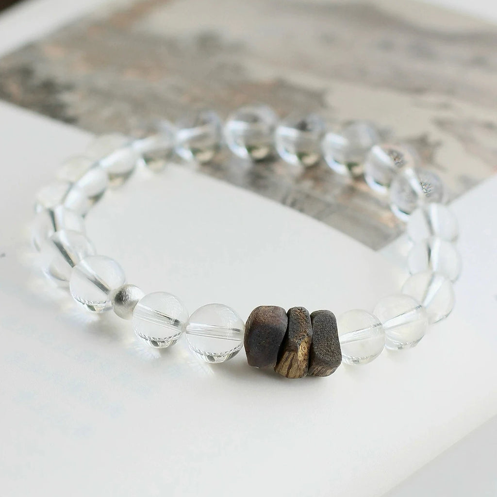 Clear quartz bead bracelet with natural agarwood, designed to cleanse energy and support inner calm