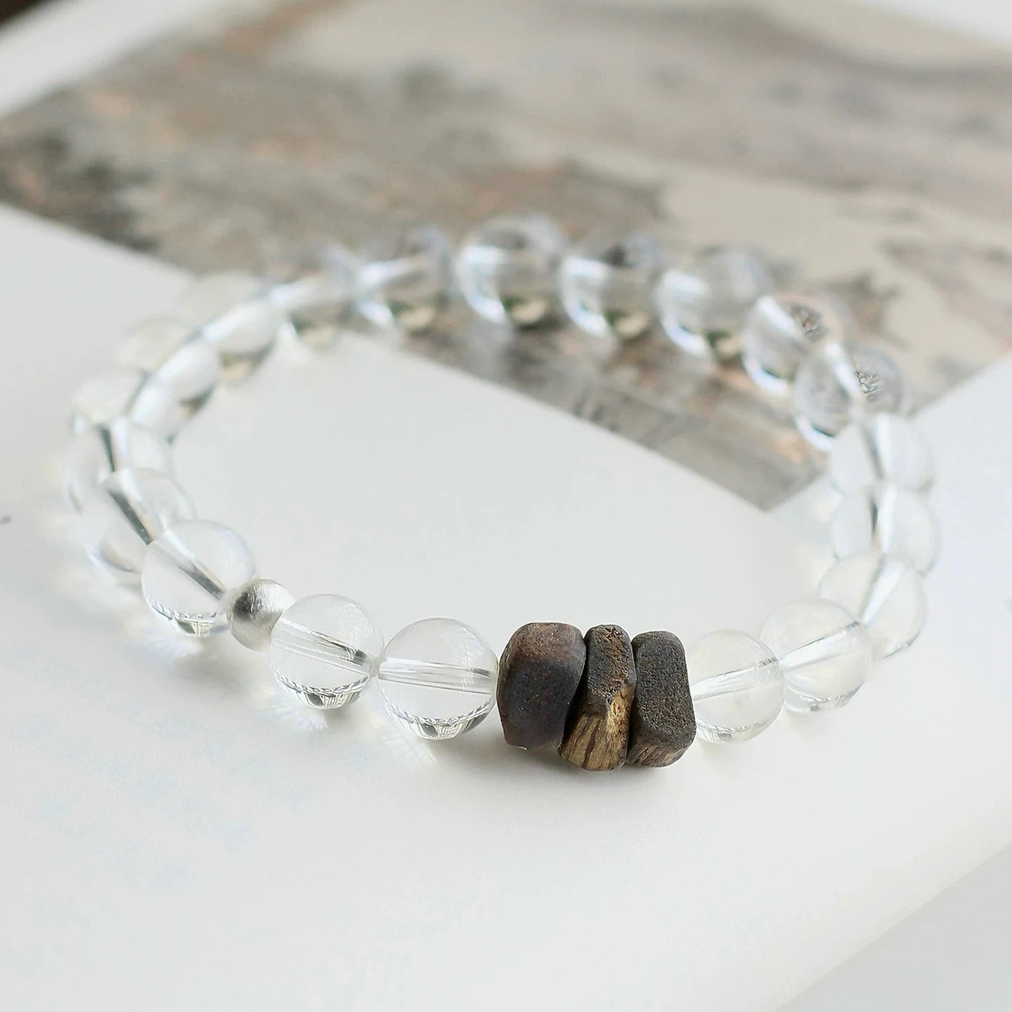 Clear quartz bead bracelet with natural agarwood, designed to cleanse energy and support inner calm
