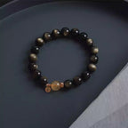 Wealth and protection crystal bracelet featuring golden obsidian and citrine stones