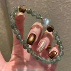 Green rutile quartz bracelet with grey moonstone and agarwood beads