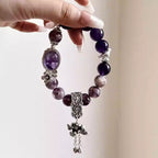 Purple amethyst bracelet featuring polished gemstones and crystals with an elegant style