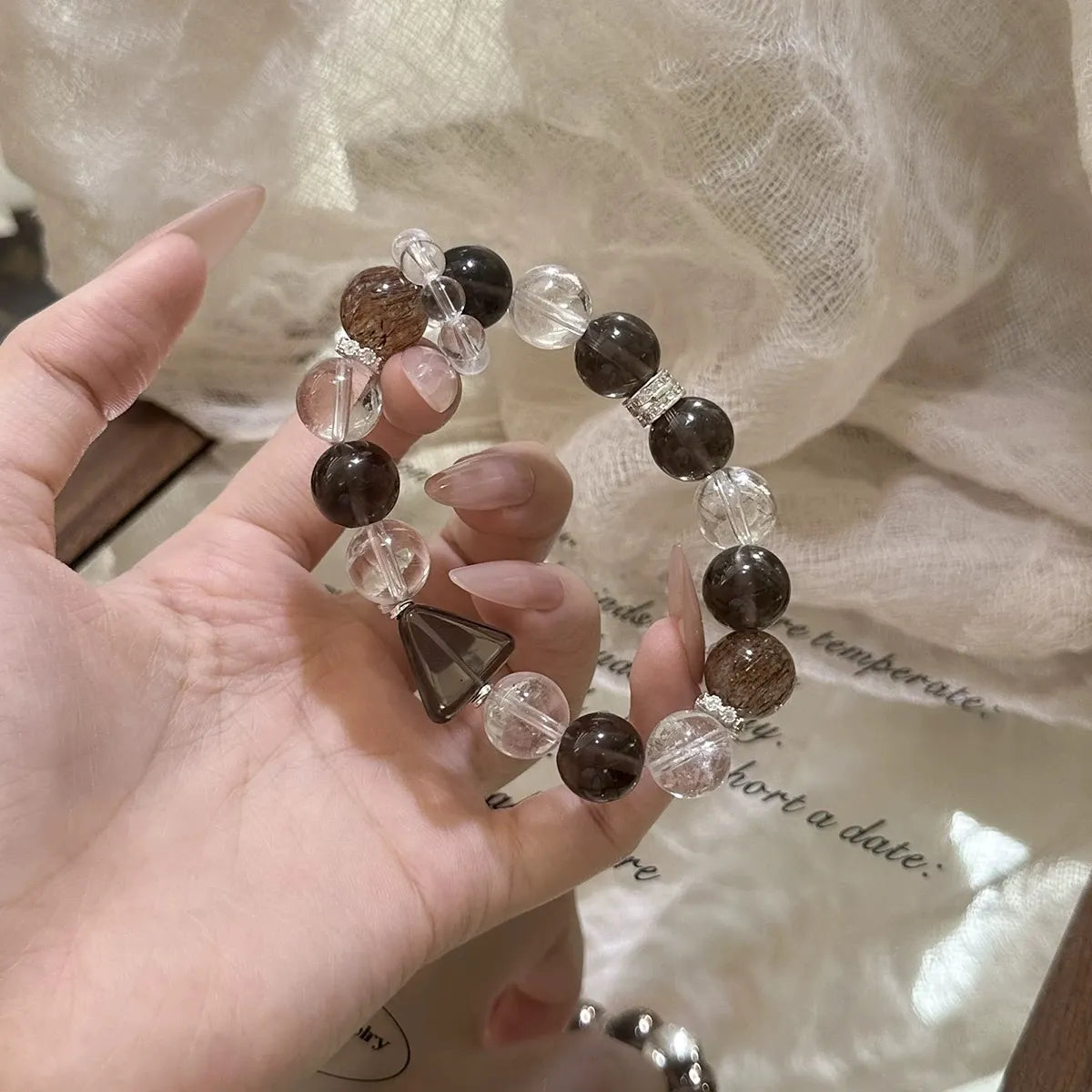 Smoky quartz bracelet paired with clear quartz beads, releasing negative energy