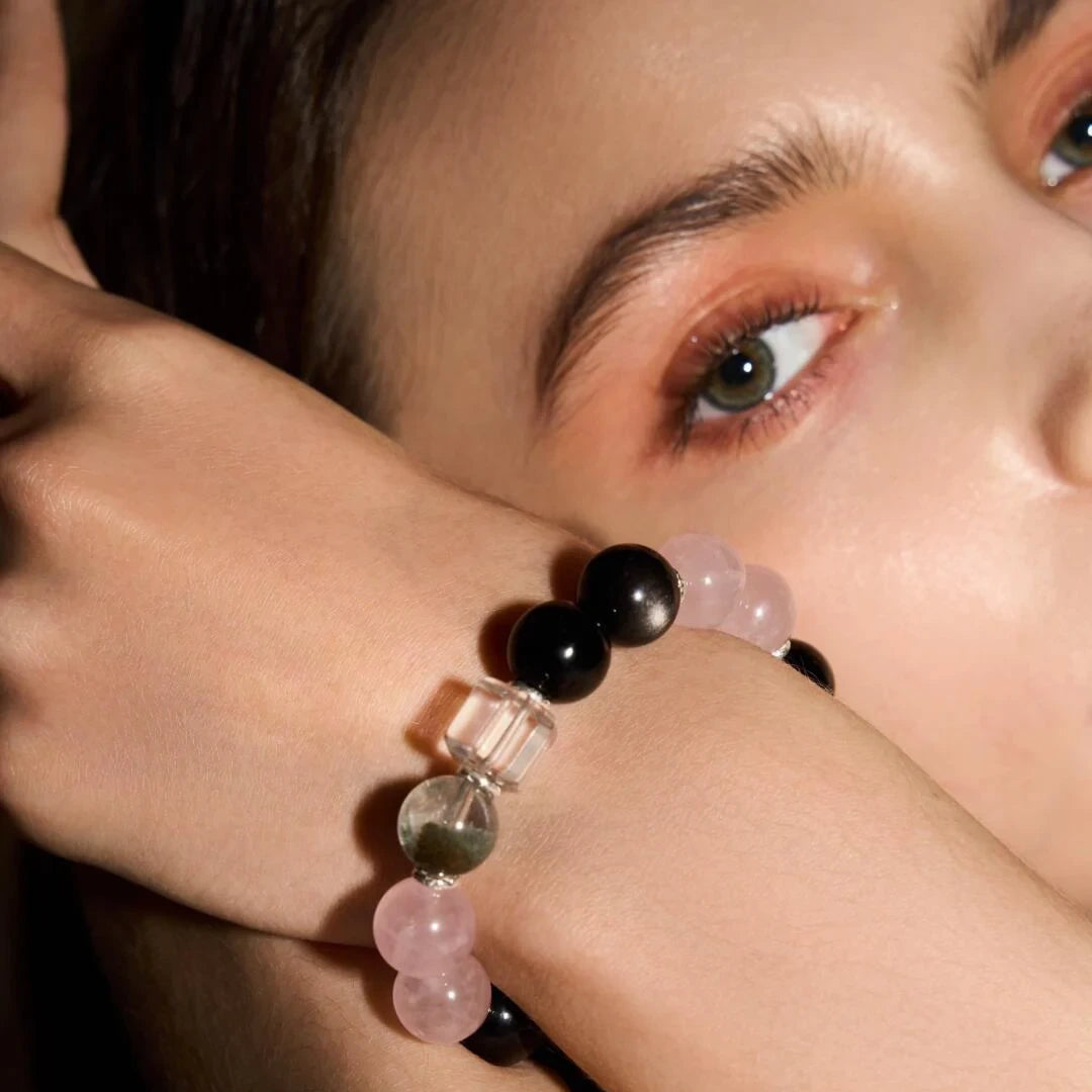 A woman wearing the Xipogem Healing Crystal  Bracelet on her wrist, showcasing its feminine energy and calm