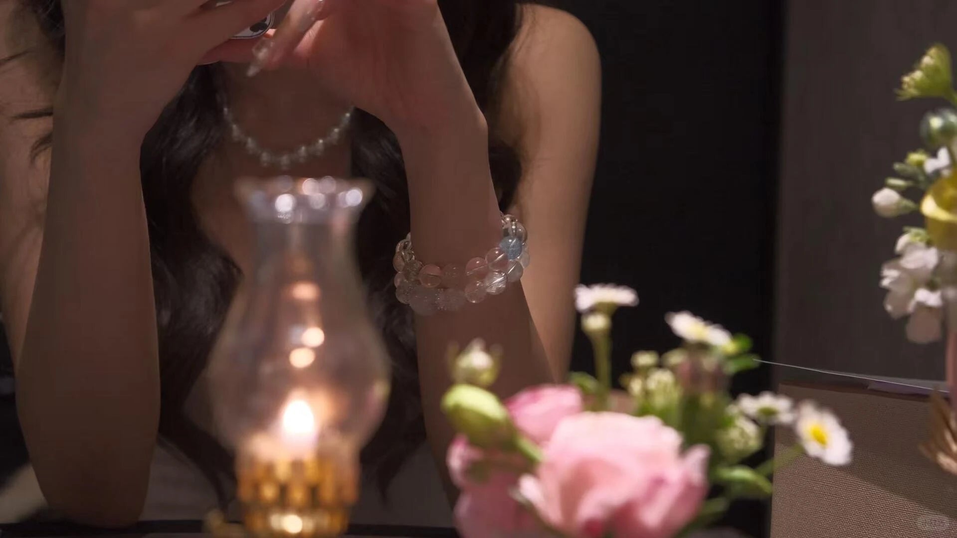 Fashion model styling multiple Xipogem crystal jewelry layered on the wrist, a trend for expressing personal energy and style