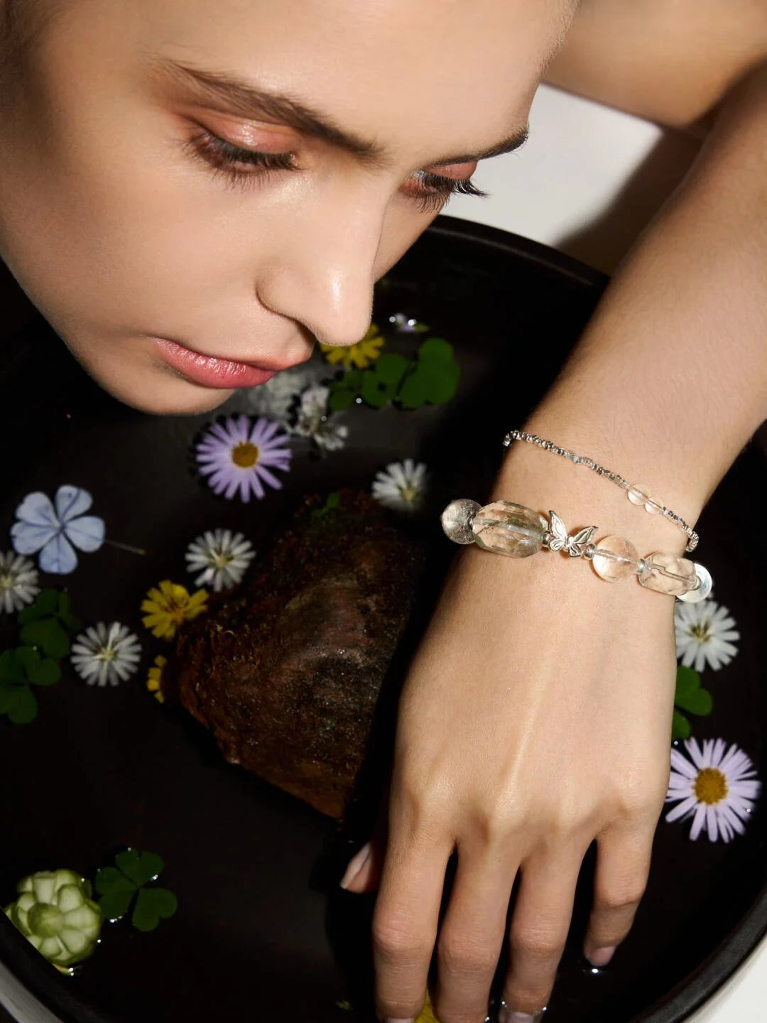 Stylish woman showcasing healing crystal bracelets for strength, protection, and positive energy