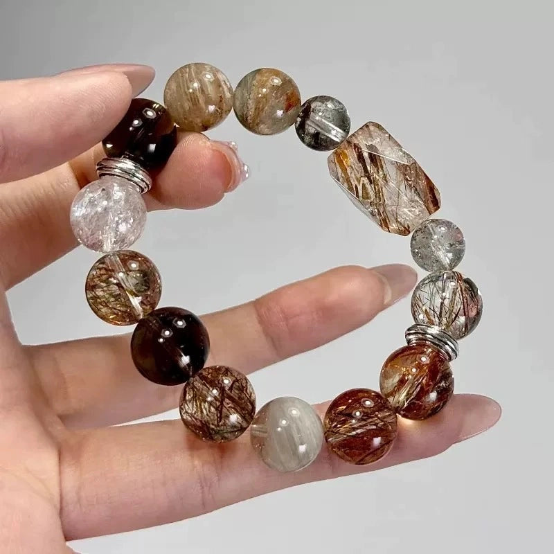 Unique black super seven and rutilated quartz bracelet, a talisman for personal power, energetic clarity, and wealth attraction.