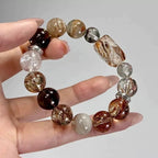 Unique black super seven and rutilated quartz bracelet, a talisman for personal power, energetic clarity, and wealth attraction.