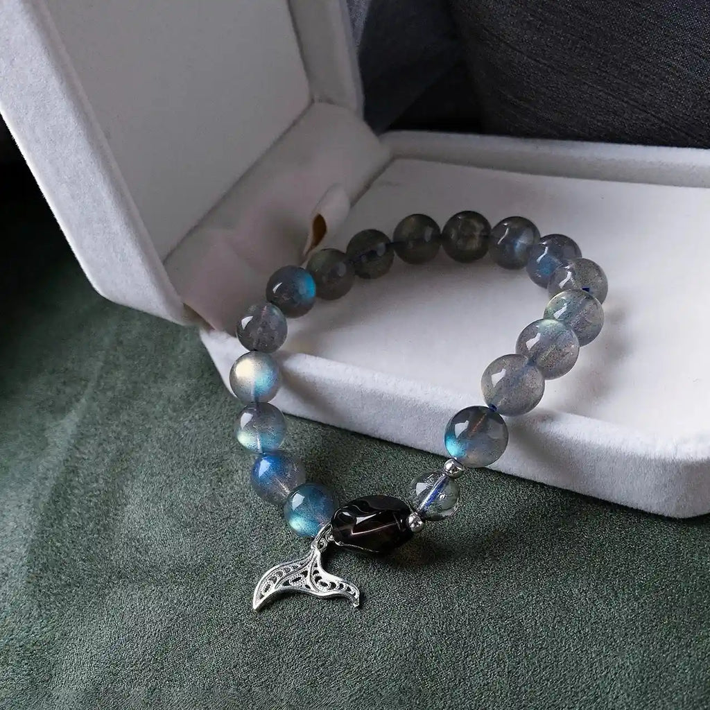 Blue moonstone bracelet with mermaid tail charm, designed to awaken intuition and connect with ocean energy.