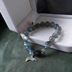 Blue moonstone bracelet with mermaid tail charm, designed to awaken intuition and connect with ocean energy.