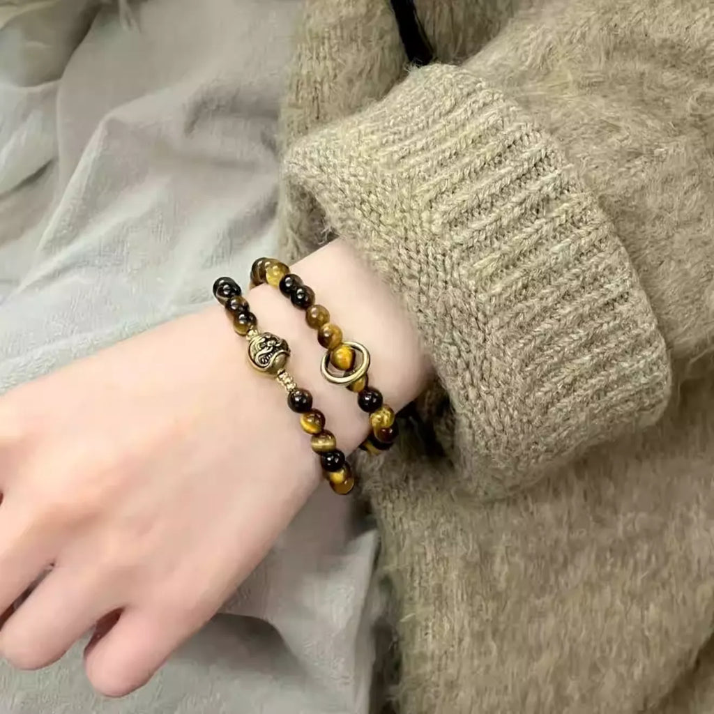 Woman wearing vintage Chinese style tiger eye bracelet, symbolizing courage, focus, and positive energy.