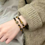 Woman wearing vintage Chinese style tiger eye bracelet, symbolizing courage, focus, and positive energy.