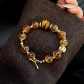 Citrine and tiger eye bracelet featuring golden yellow and brown striped crystal beads.