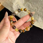 Close-up of citrine and tiger eye bracelet, designed to attract prosperity, confidence, and grounded energy.