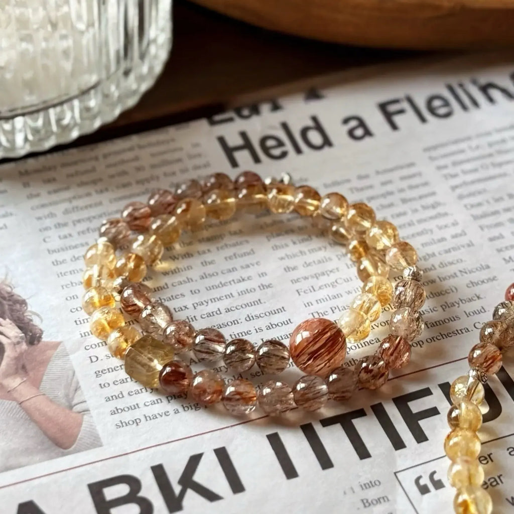 Close-up of a double strand crystal bracelet highlighting citrine clarity and super seven inclusions.