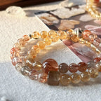 Handcrafted double strand bracelet combining translucent citrine with deep-toned super seven quartz.