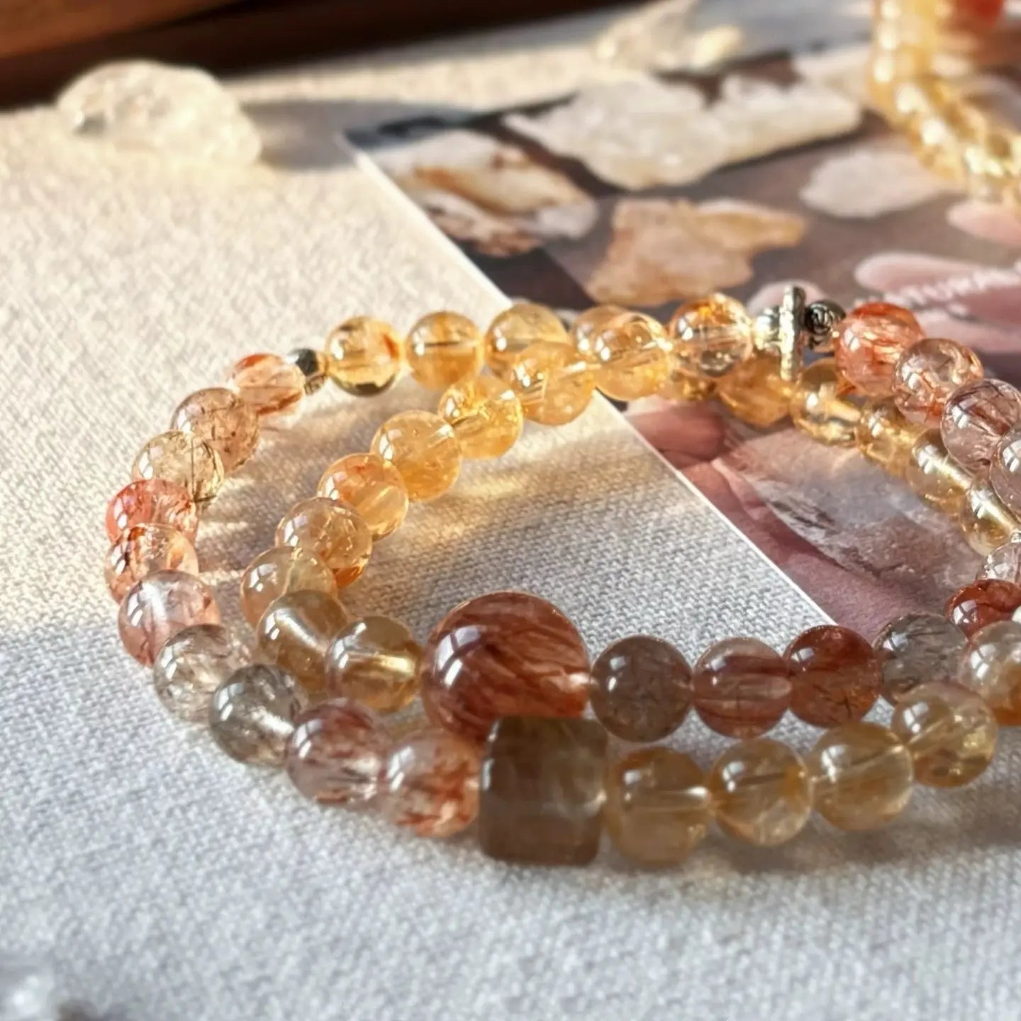 Handcrafted double strand bracelet combining translucent citrine with deep-toned super seven quartz.