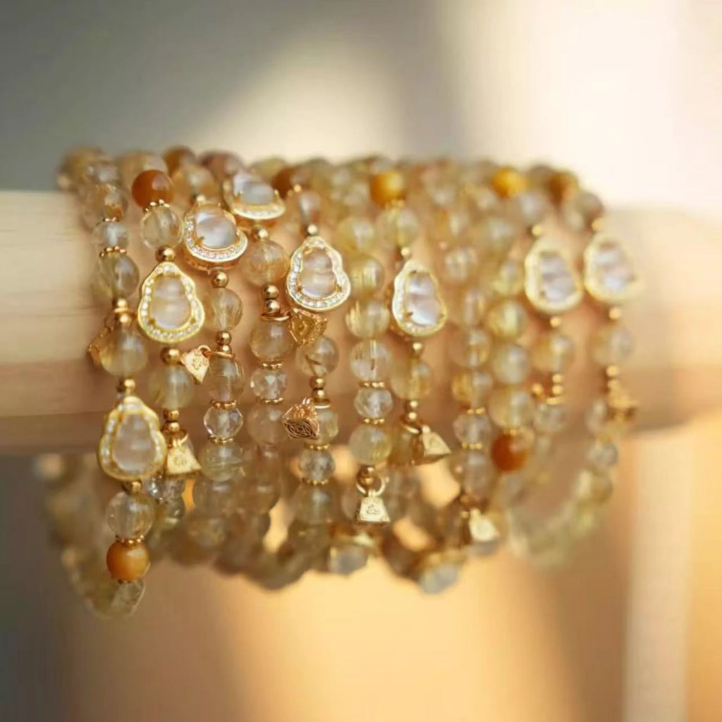Citrine crystal bracelet with polished golden beads and a small gold gourd charm, handcrafted crystal bracelet.