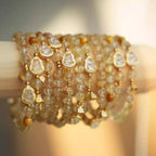 Citrine crystal bracelet with polished golden beads and a small gold gourd charm, handcrafted crystal bracelet.