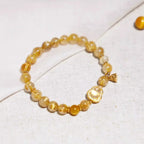 Natural citrine crystal bracelet with gold charm accent, a delicate crystal bracelet piece for daily wear.