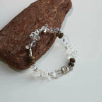 Energy bracelet made with polished clear quartz and traditional agarwood beads.