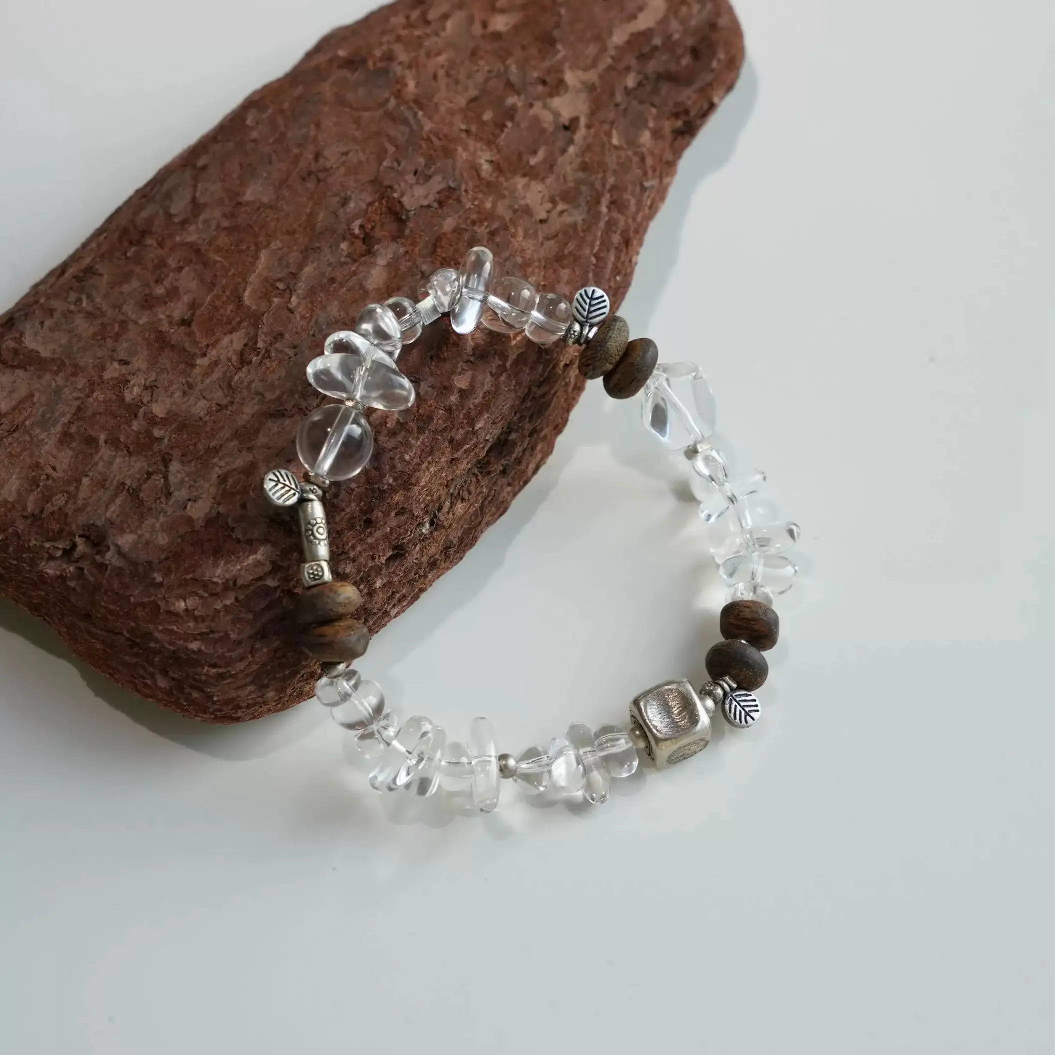 Energy bracelet made with polished clear quartz and traditional agarwood beads.