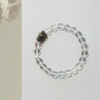 Natural stone bracelet with polished clear quartz and agarwood, balanced layered design for everyday wear.