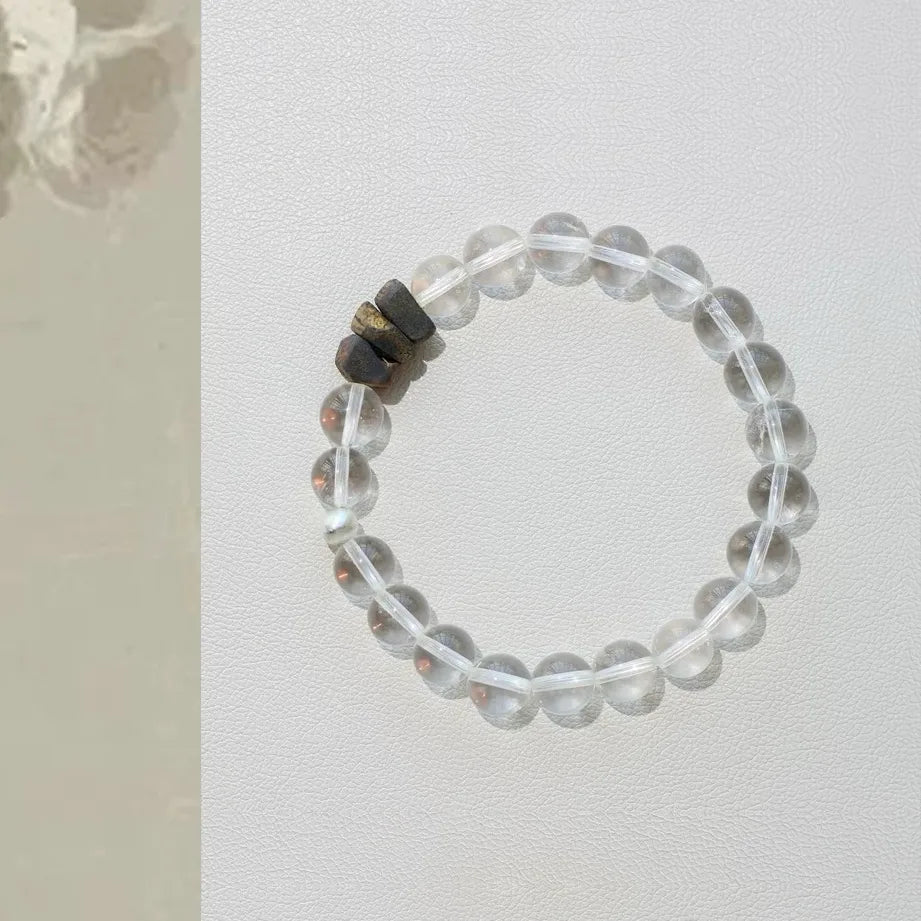 Natural stone bracelet with polished clear quartz and agarwood, balanced layered design for everyday wear.