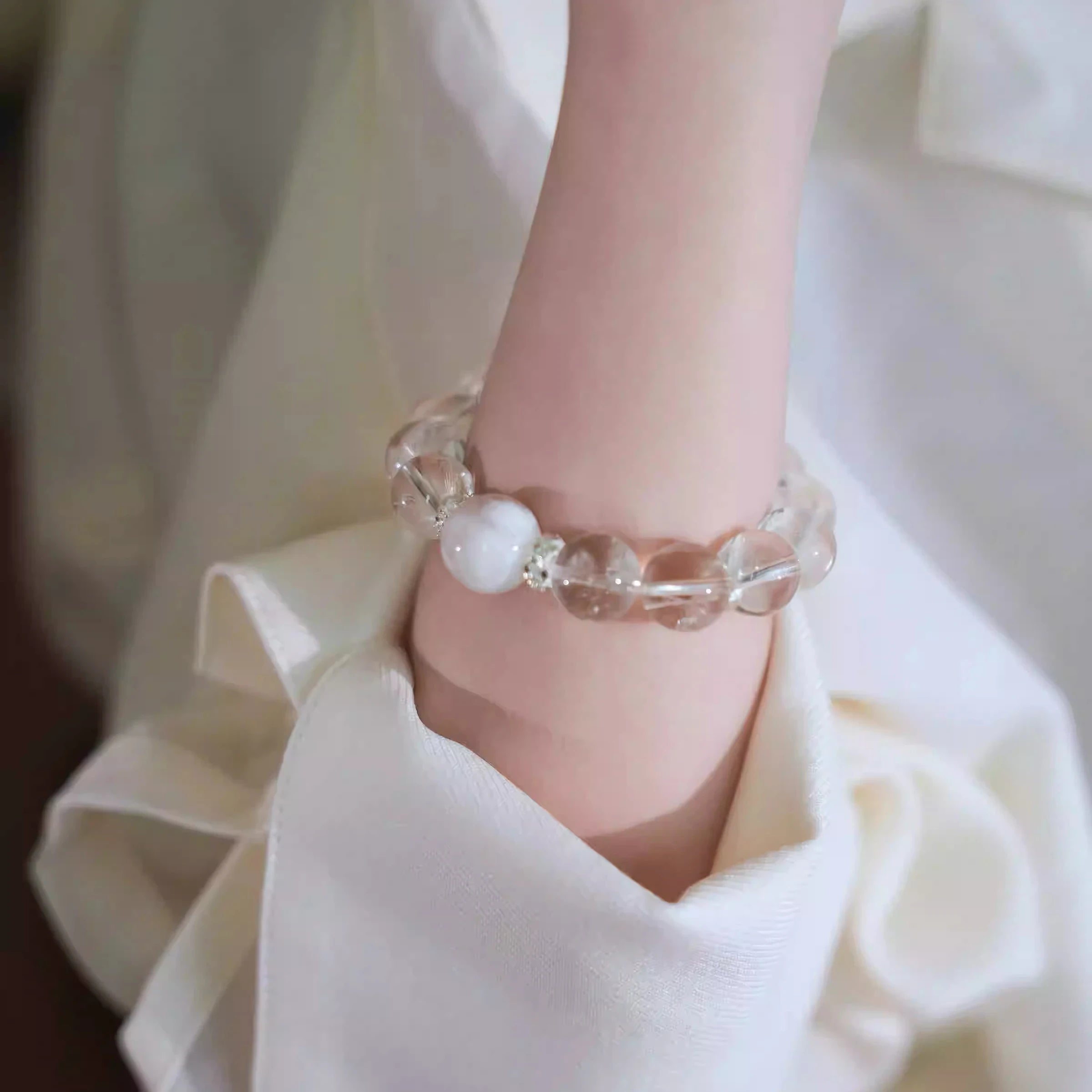 Woman wearing designer clear quartz bracelet for healing, calm, and positive energy – stylish crystal jewelry for spiritual balance.