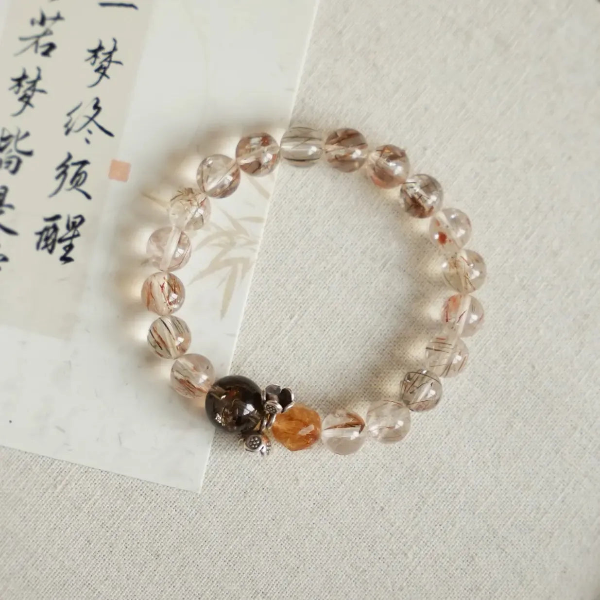 Bracelet featuring golden citrine beads and copper rutilated quartz with needle-like inclusions.