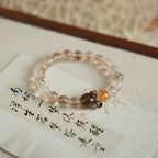 Natural stone bracelet where copper rutilated quartz and citrine create depth and visual interest.