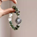 Green crystal bracelet featuring polished green quartz beads, handcrafted natural crystal jewelry.