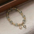 Green phantom quartz bracelet designed as a talisman for wealth, personal growth, and transformation.