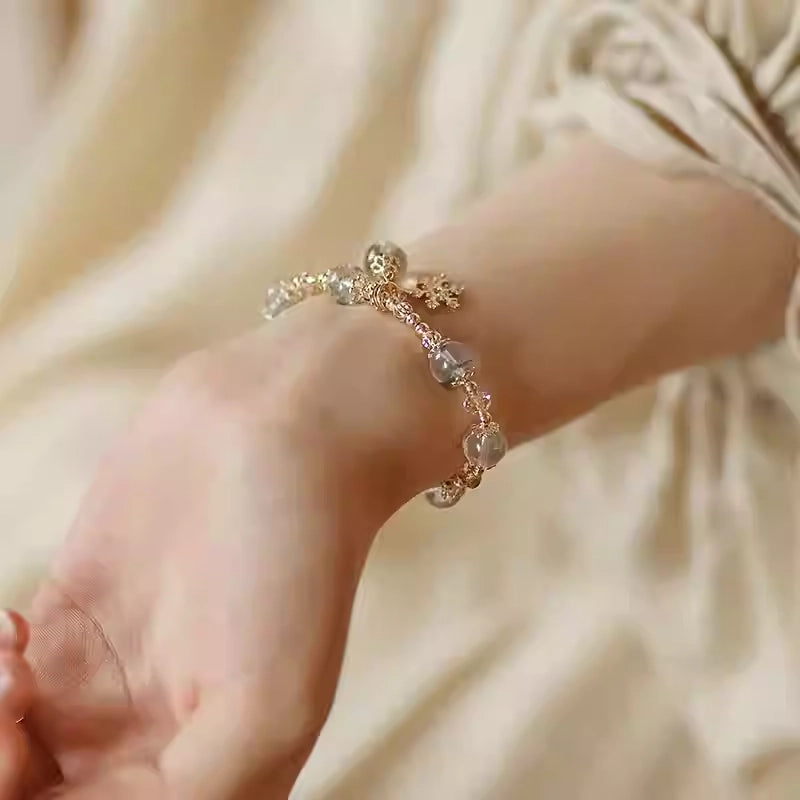 Woman wearing green phantom quartz bracelet as a talisman for wealth, personal transformation, and positive energy flow.