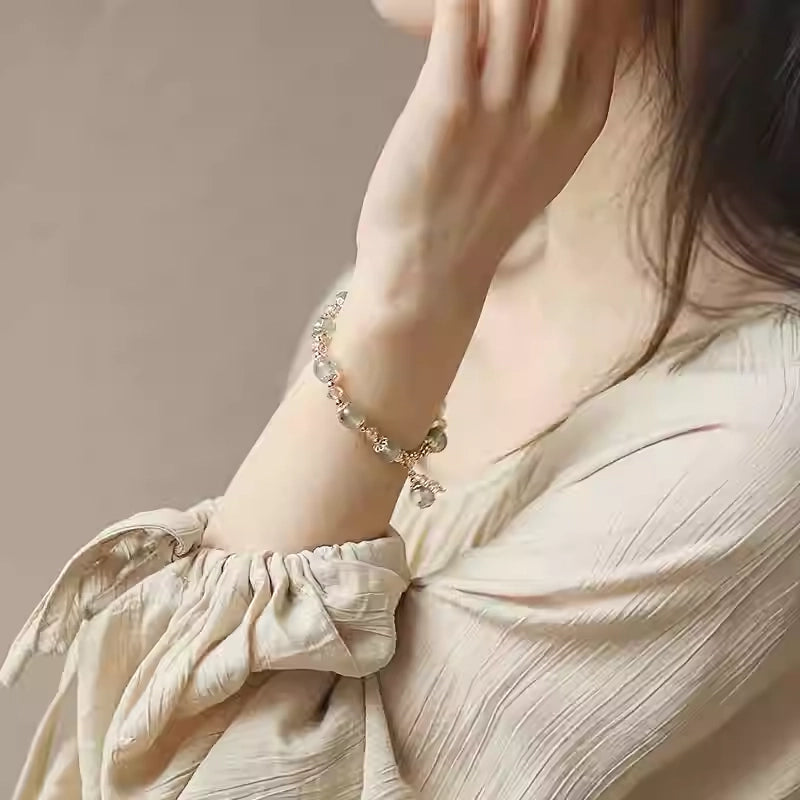 Model showcasing green phantom quartz bracelet, symbolizing abundance, personal growth, and transformative energy.