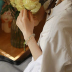 Model wearing double wrap green phantom quartz bracelet, promoting abundance, professional growth, and good fortune – natural healing crystal accessory.