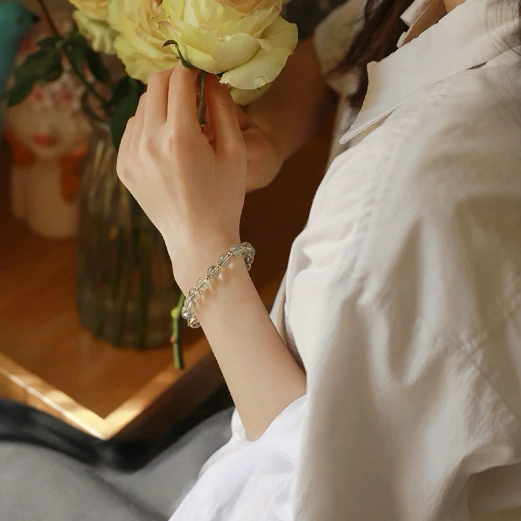 Model wearing double wrap green phantom quartz bracelet, promoting abundance, professional growth, and good fortune – natural healing crystal accessory.