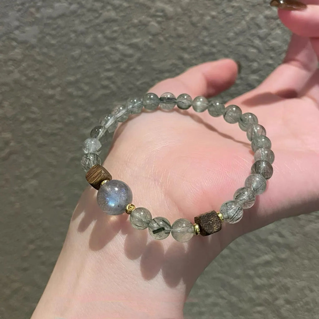 Natural green rutilated quartz, grey moonstone and agarwood bracelet, symbolizing abundance, emotional balance, and spiritual calm.
