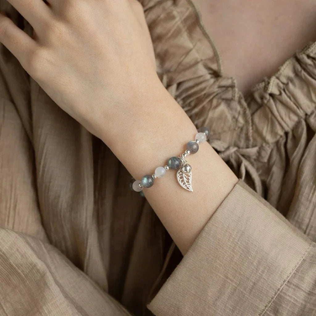 Model showcasing grey and white moonstone bracelet, designed to enhance intuition, emotional balance, and spiritual well-being.