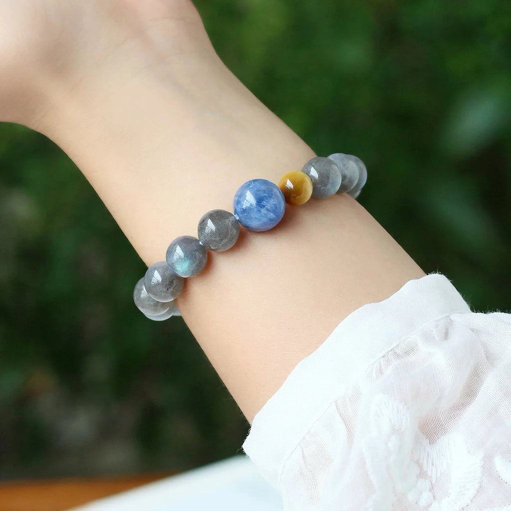 Model wearing grey moonstone and blue kyanite bracelet, expressing calm presence, intuitive insight, and spiritual alignment.