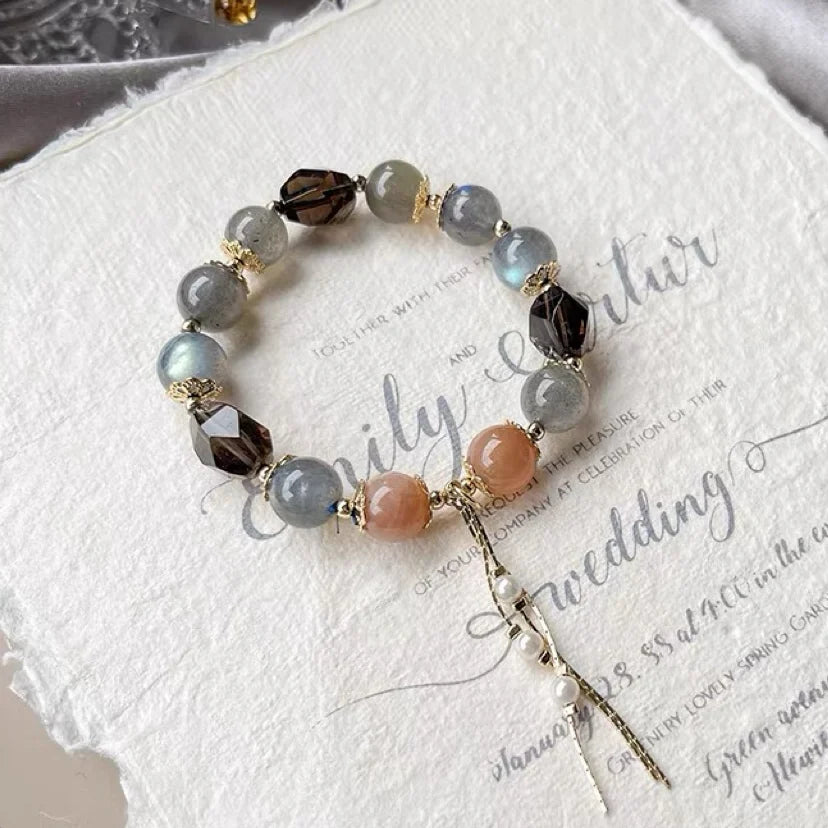 Grey and orange moonstone with smoky quartz bracelet displayed as a symbol of balance, confidence, and grounded energy.