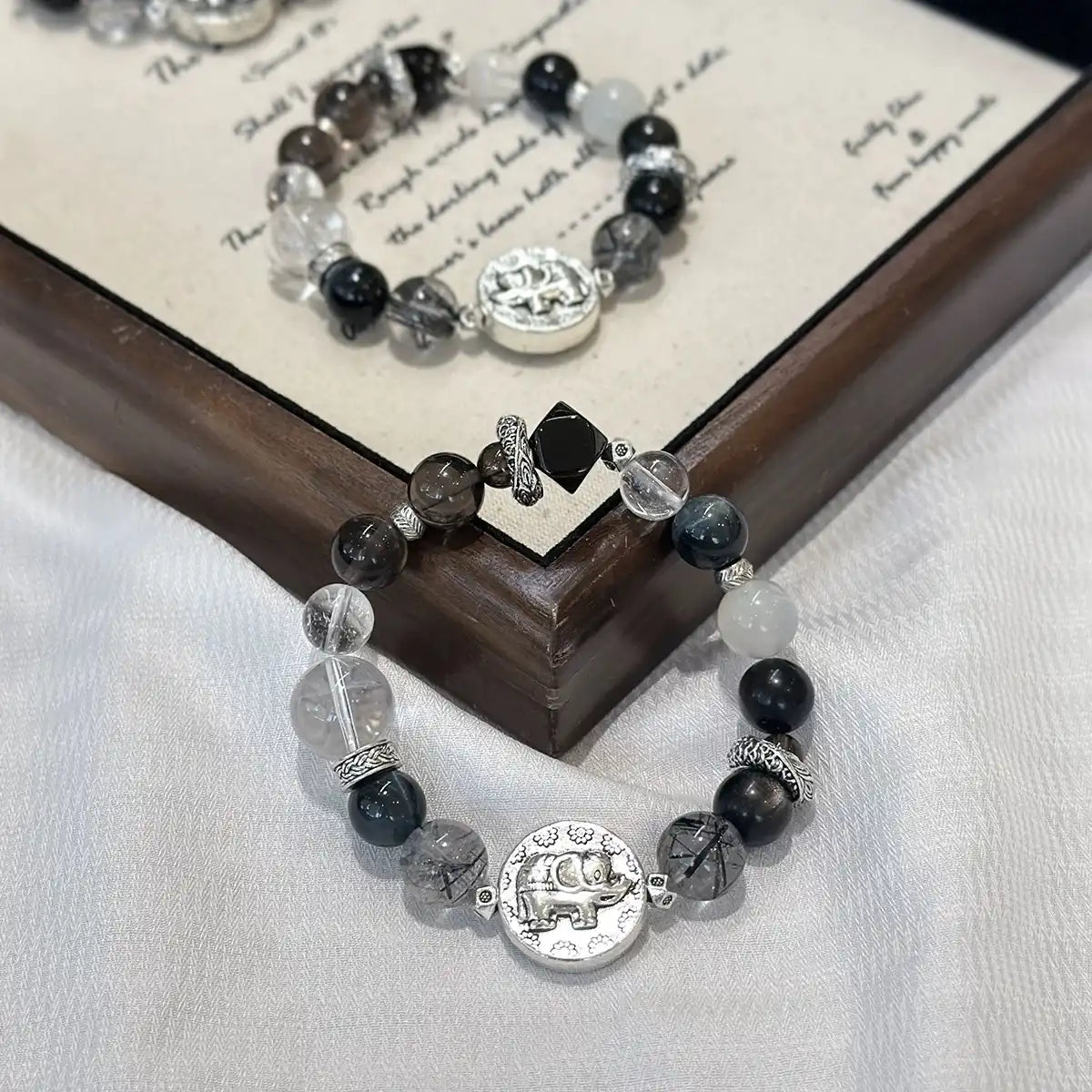 Mixed black crystal bracelet with elephant charm for protection, strength, and grounding energy – spiritual healing jewelry.
