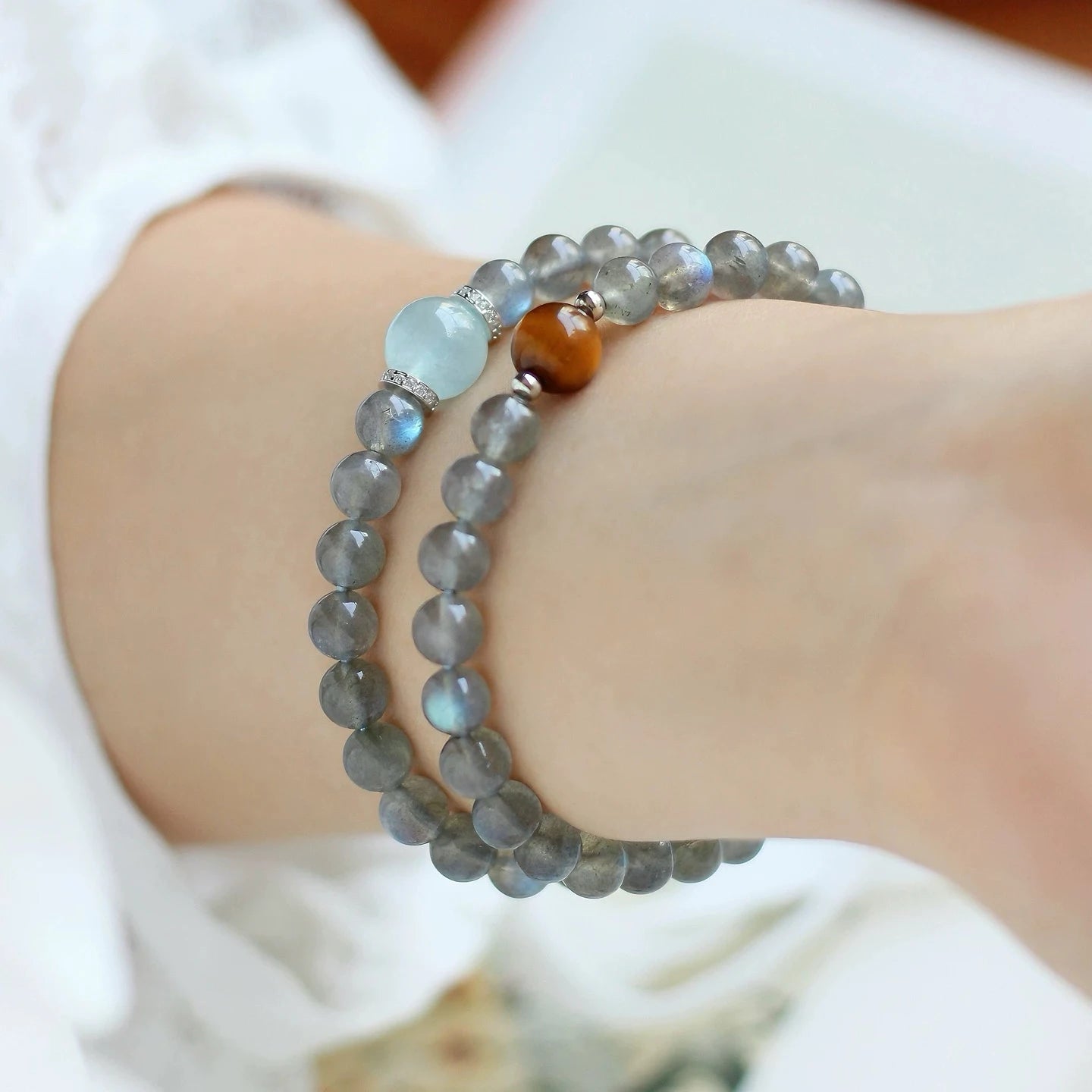 Model showcasing double wrap moonstone and aquamarine bracelet, highlighting serene energy, mindfulness, and intuitive guidance.