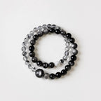 Natural crystal bracelet featuring double strand silver obsidian, showing subtle metallic sheen.