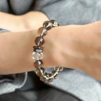 Woman wearing natural smoky quartz bracelet to stay grounded, calm, and energetically cleansed.