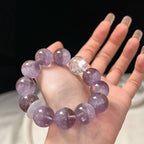 Close-up of amethyst and white phantom quartz bracelet, promoting mental clarity, intuition, and spiritual growth.
