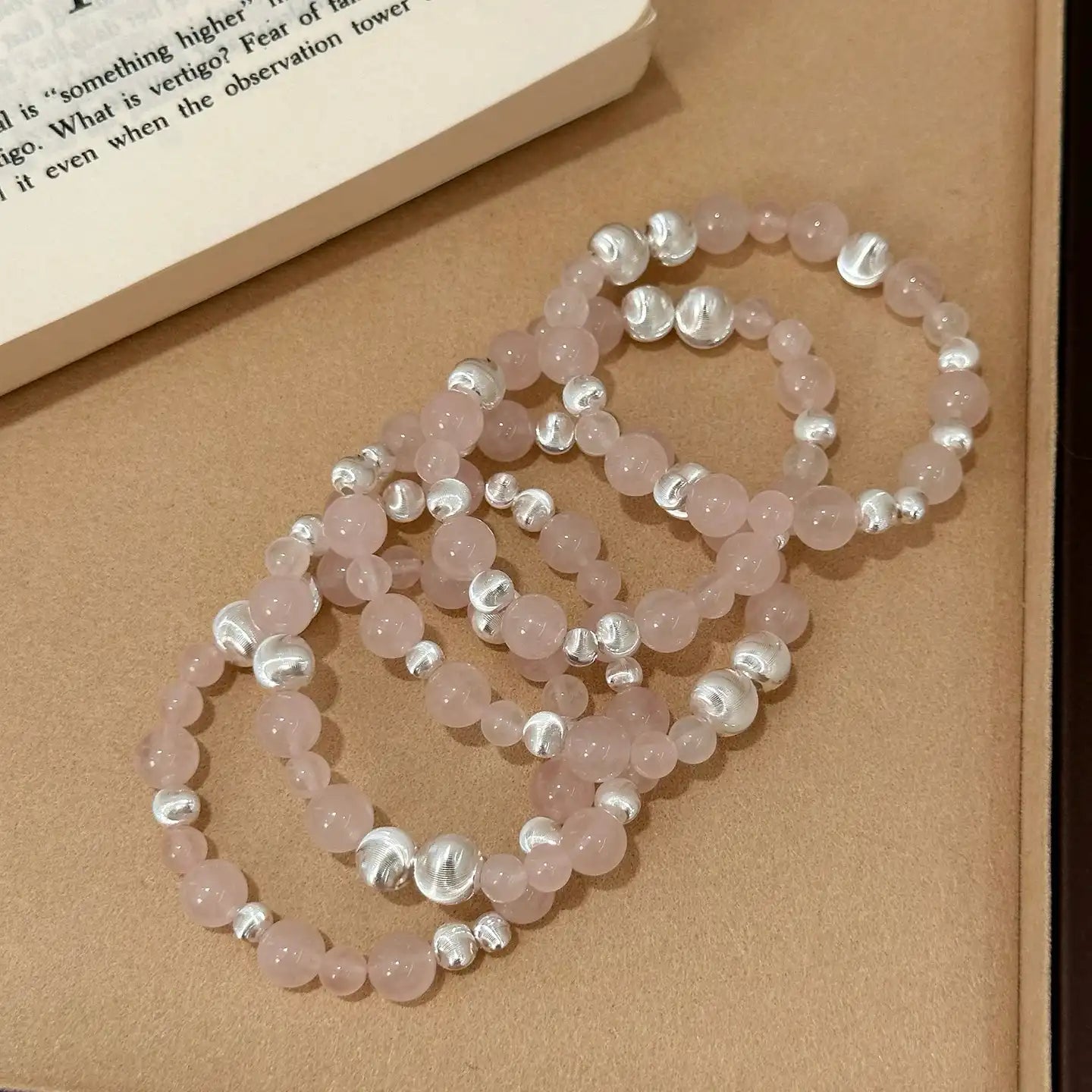 Rose quartz bracelet with silver cat’s eye beads for love, emotional healing, and heart chakra balance – designer crystal jewelry.