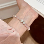 Woman wearing rose quartz bracelet with silver cat’s eye beads for love, self-care, and emotional harmony – stylish healing crystal jewelry.
