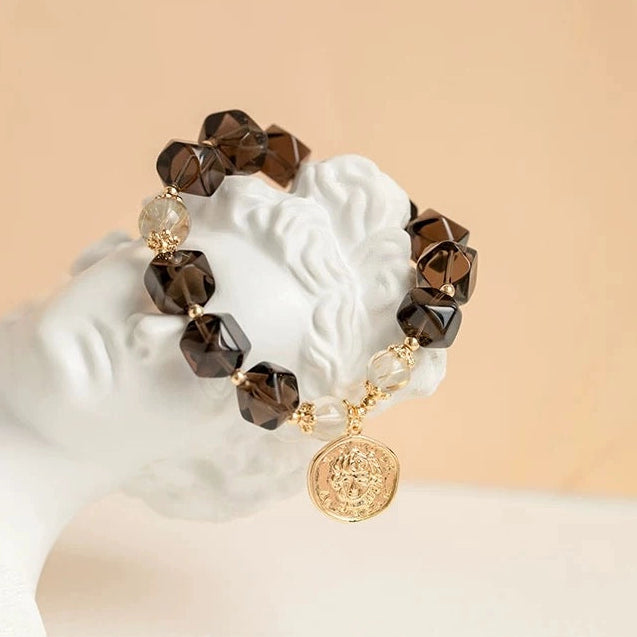 Smoky quartz bracelet with golden rutilated quartz for grounding, wealth, and modern energy – natural healing crystal jewelry.